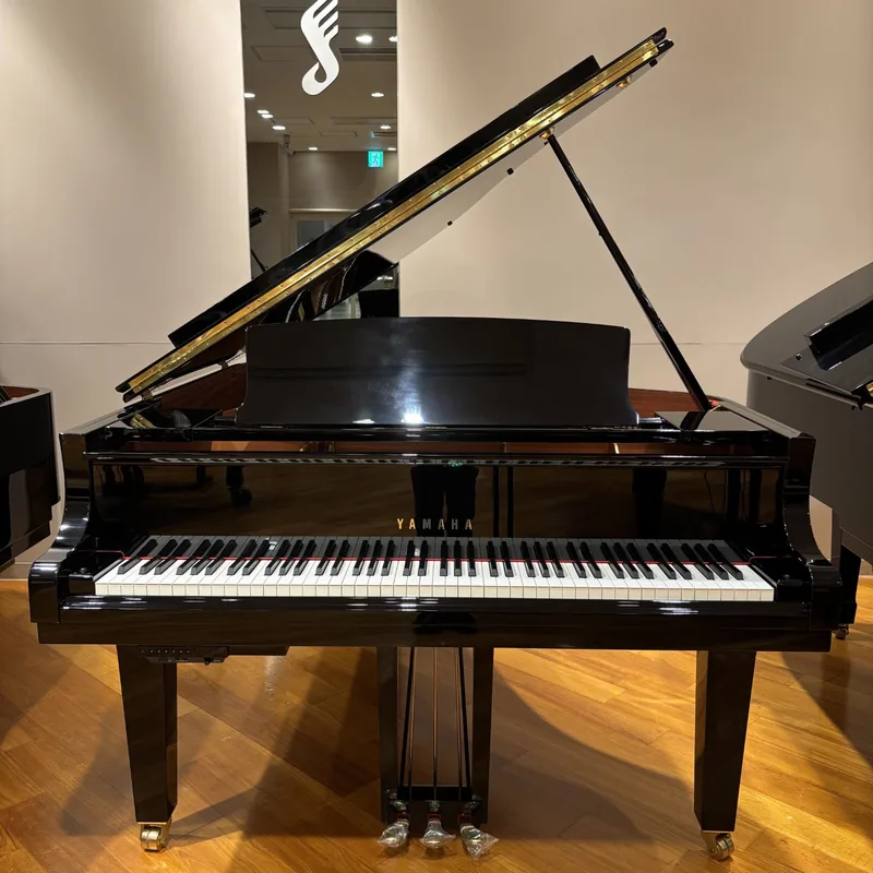 Pre-loved Yamaha C3X grand piano in polished ebony, lid open